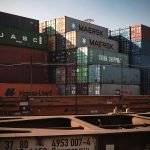 A view of colorful cargo containers stacked at a bustling industrial harbor.
